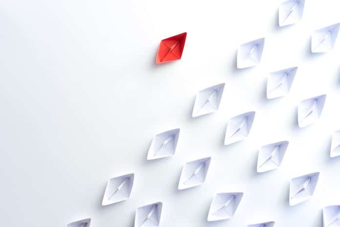 Group of paper ship in one direction and with one individual is different. Business for Innovative solution concept.